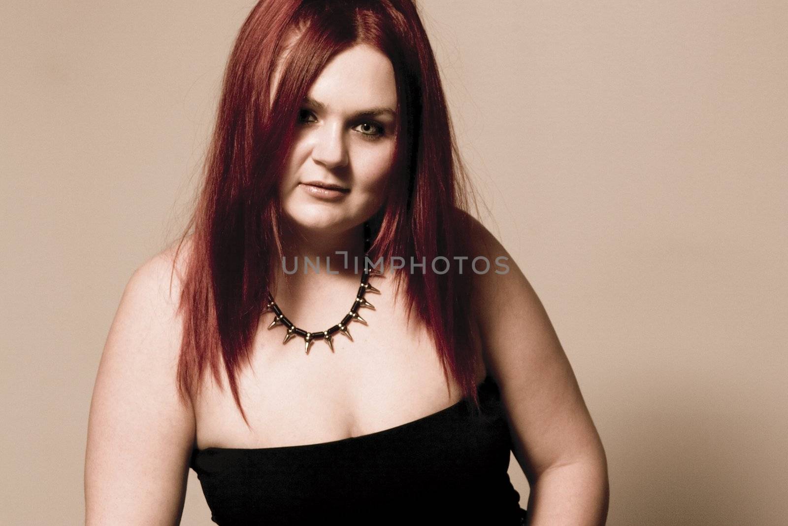 Red hair female model in suggestive position and goth look