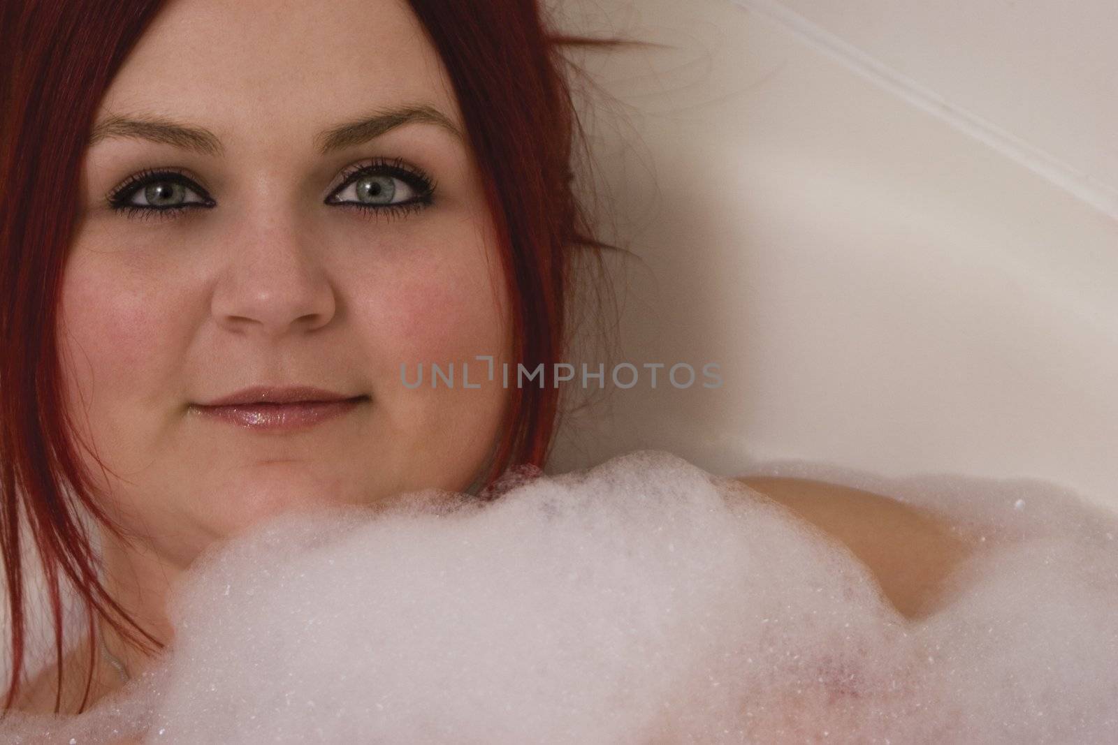 close up of a red hair model in bubble bath