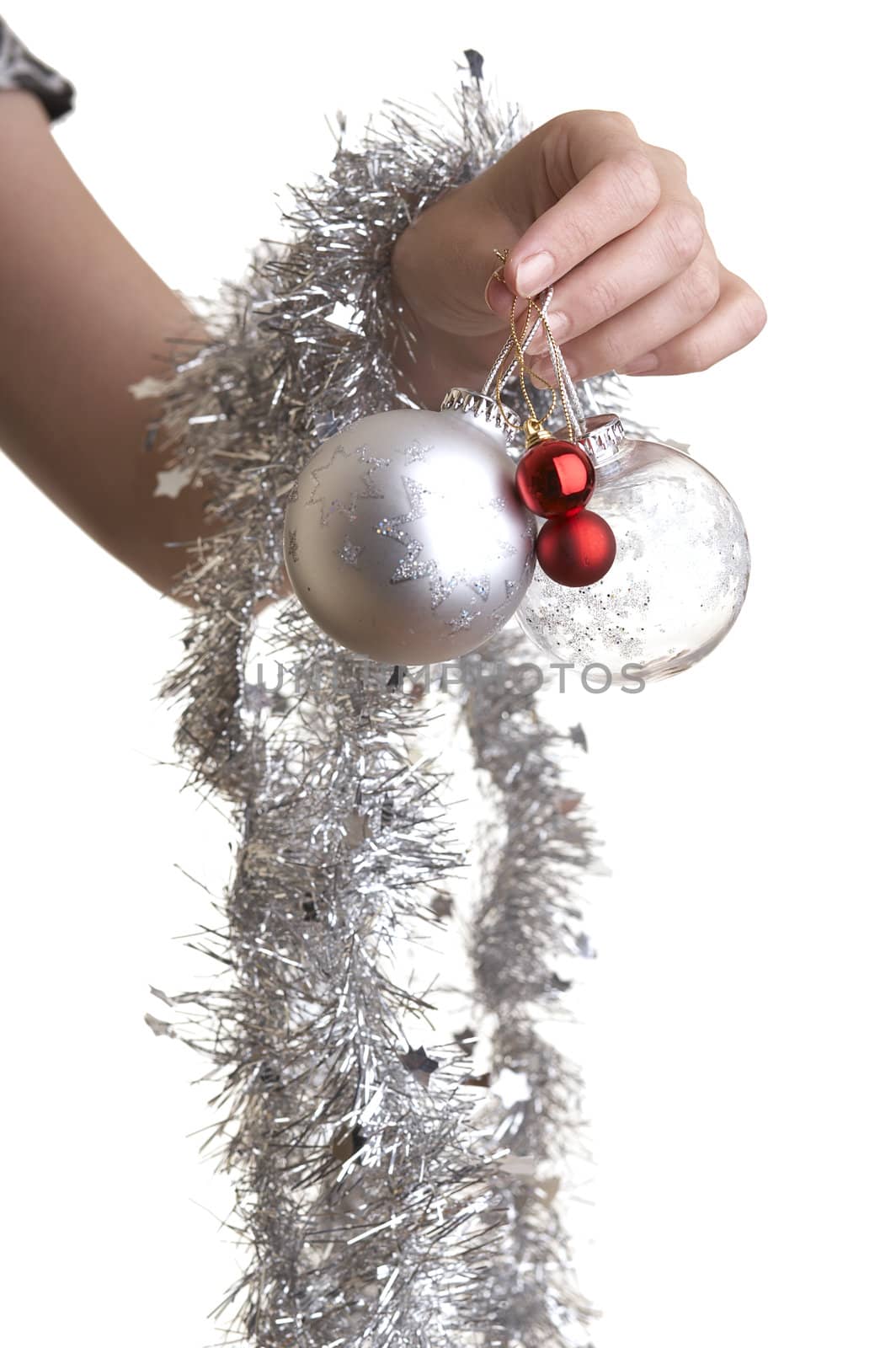 Woman about to hang a Christmas ornaments