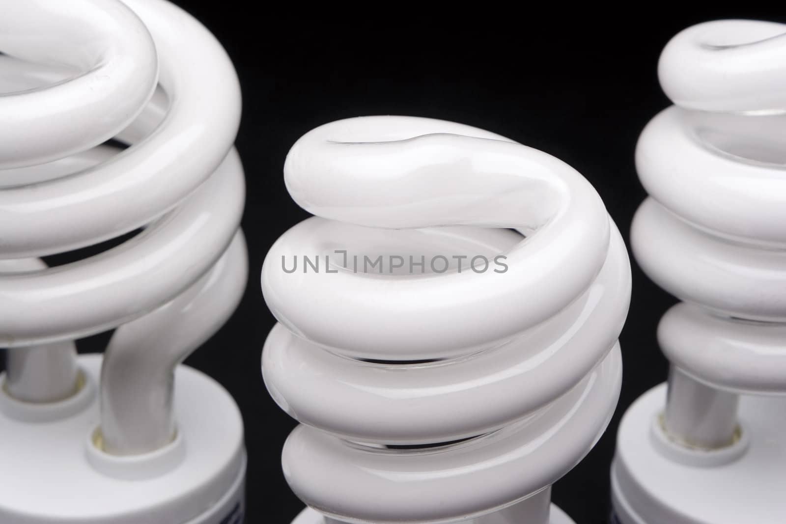 Close up of three compact fluorescent bulb head