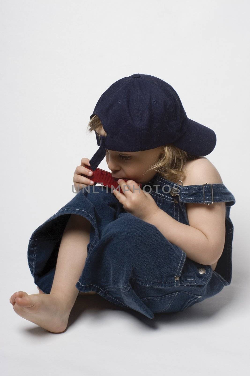 Kid playing harmonica by mypstudio