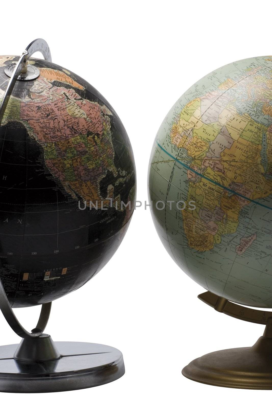 Terrestrial globe in black color showing the american continent facing a blue globe showing the african continent