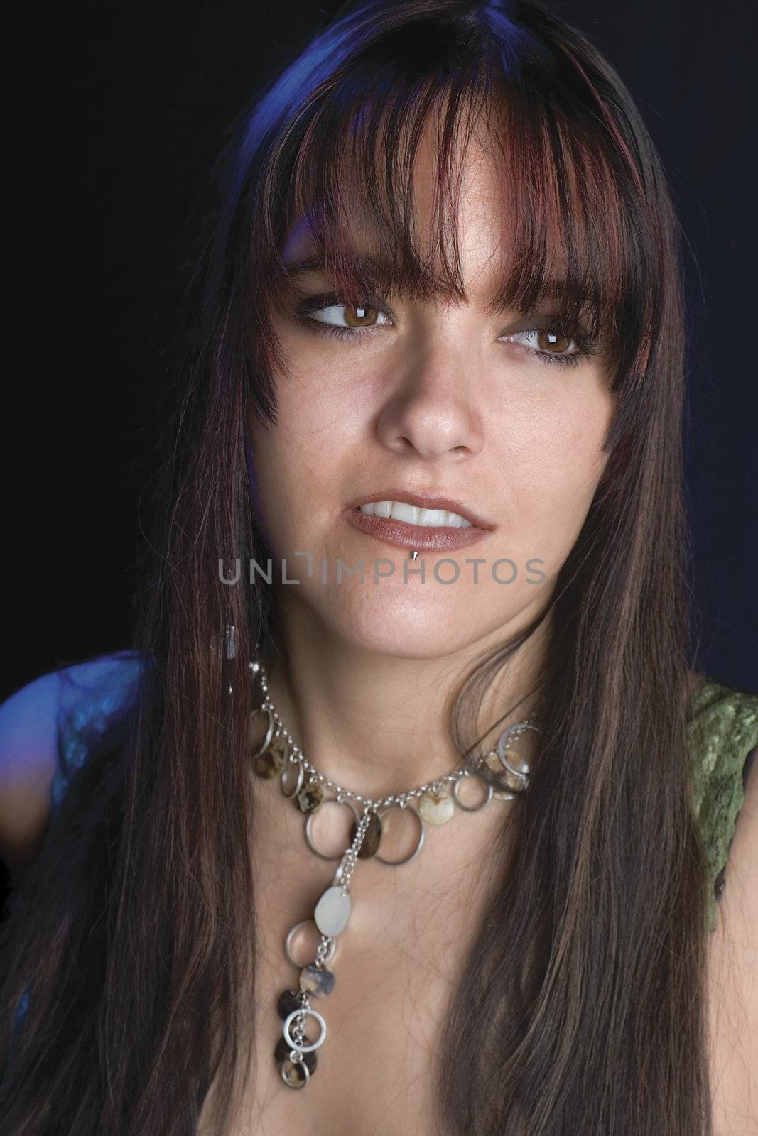 Close up portrait of fashion model in relaxe position with blue light reflecting on shoulder