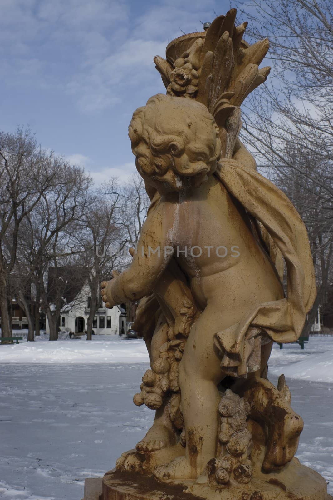 Cherubin statue during winter in a park