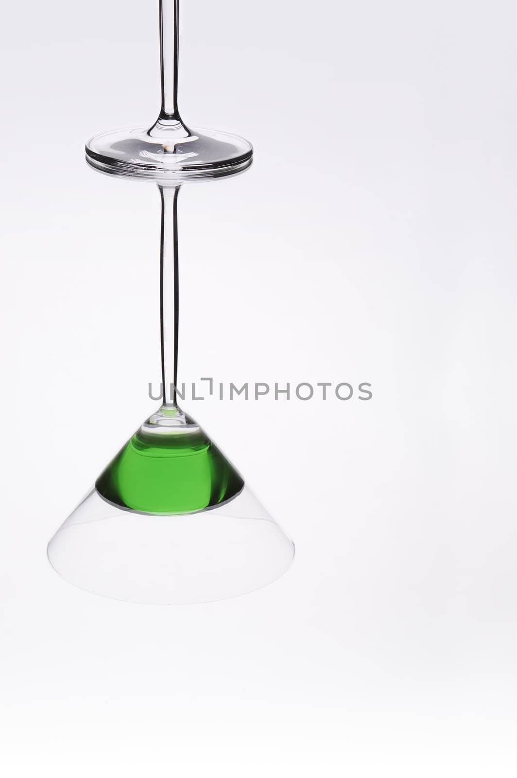 Cocktail glass reflection on shiny mirror like surface