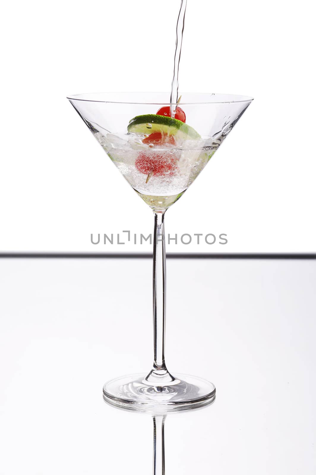 pouring cocktail in to the glass on bar table