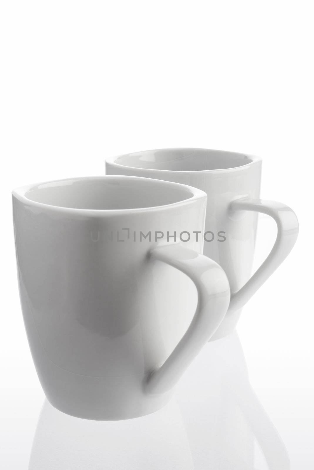 Pair of white coffee cups on white background