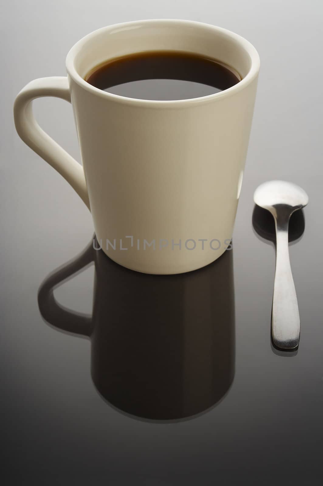 Coffee cup on black background with spoon