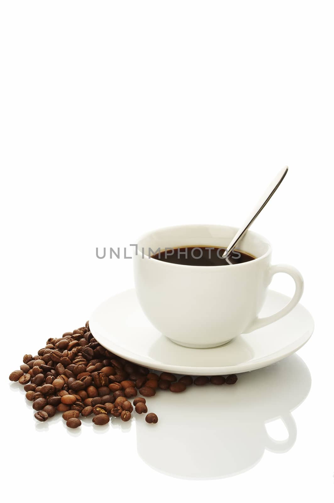 White coffee cup with coffee beans