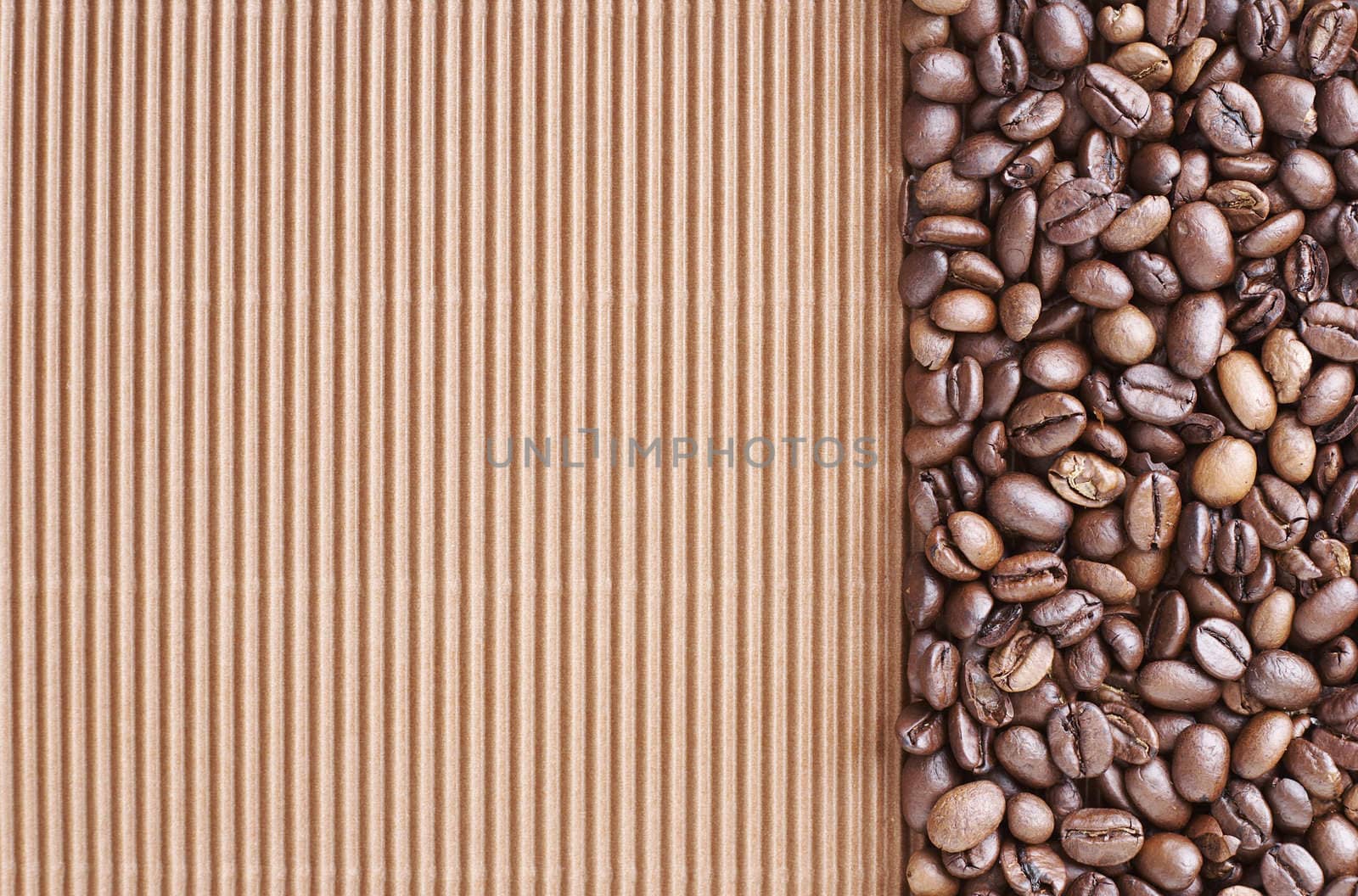 Coffee beans over a brown curly cardboard 