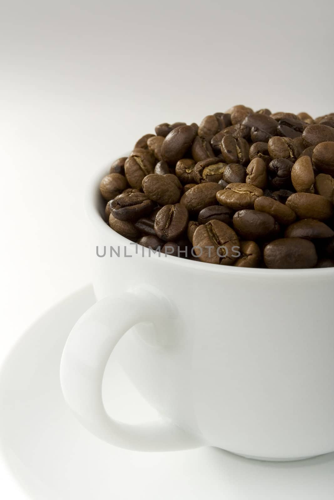 Coffee cup filled with roasted coffee beans