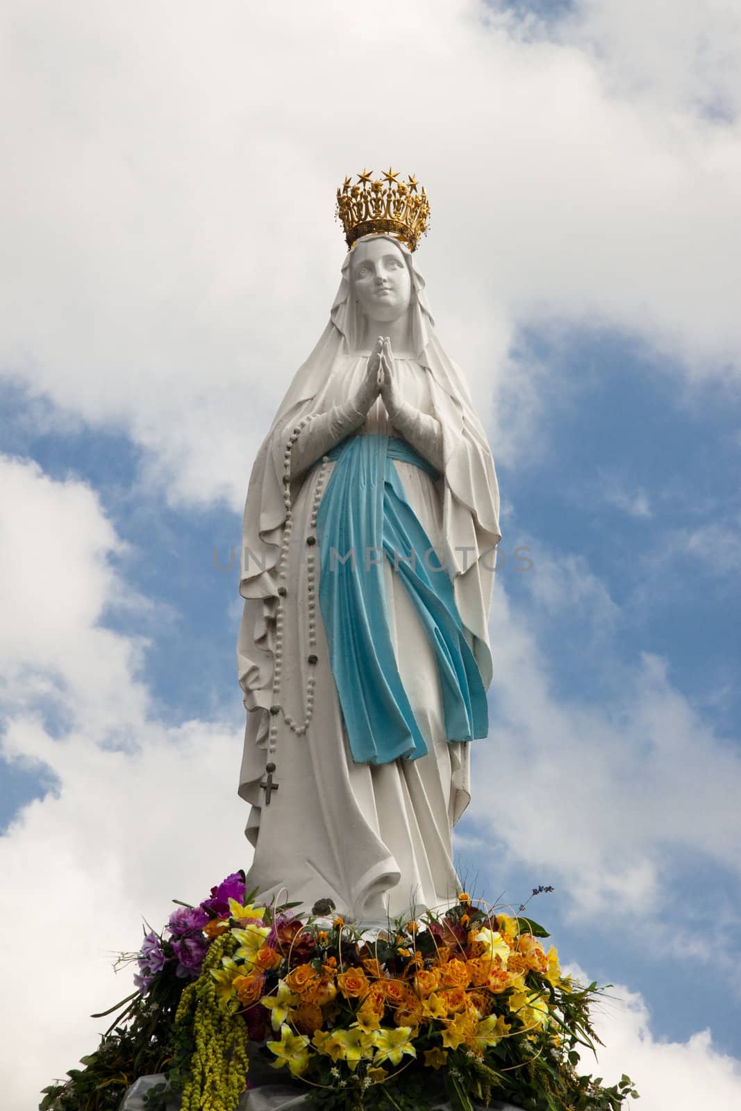 Big figure of the Madonna in Lourdes - France. Cloudy day