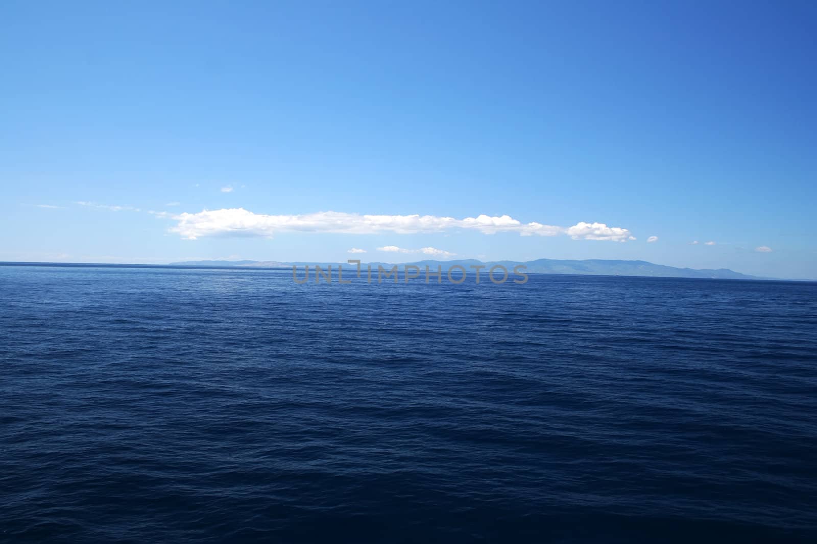 Perfect Blue Sea with coast on horizon