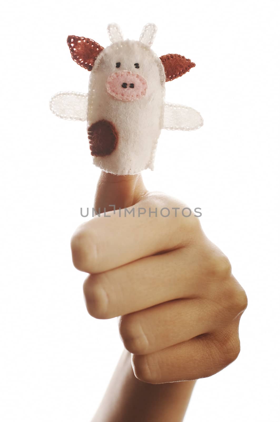 Girl's hand with animal finger puppet (cow)