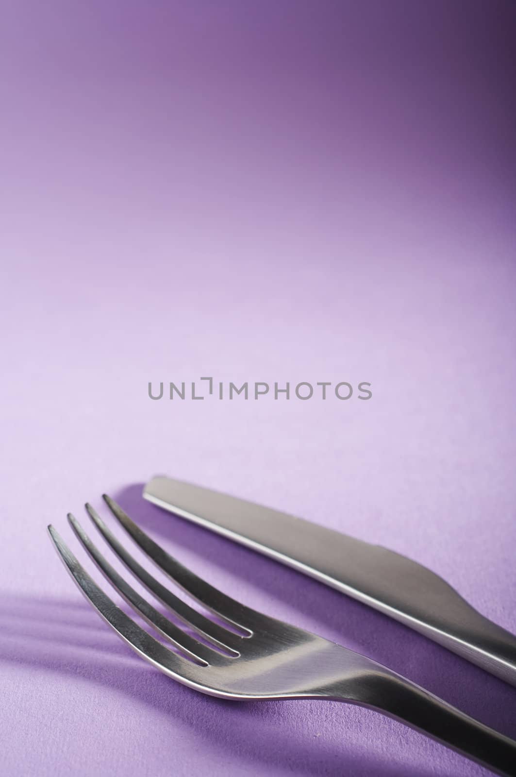Fork and spoon on the purple table