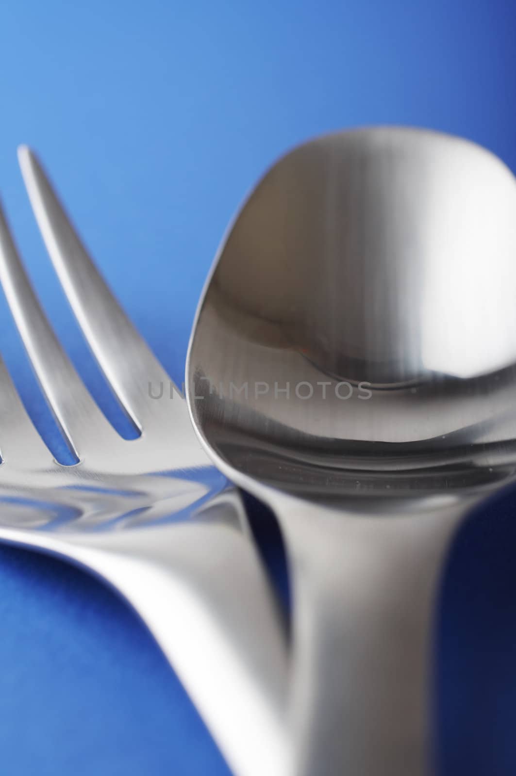 close up of spoon and fork on the blue table