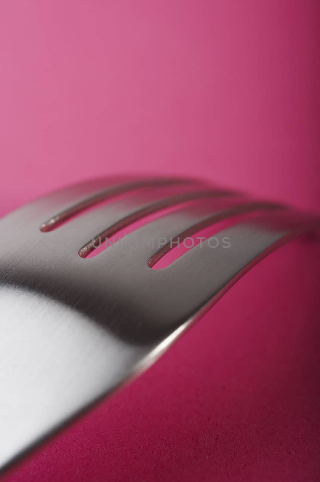 Close up of fork on the pink table