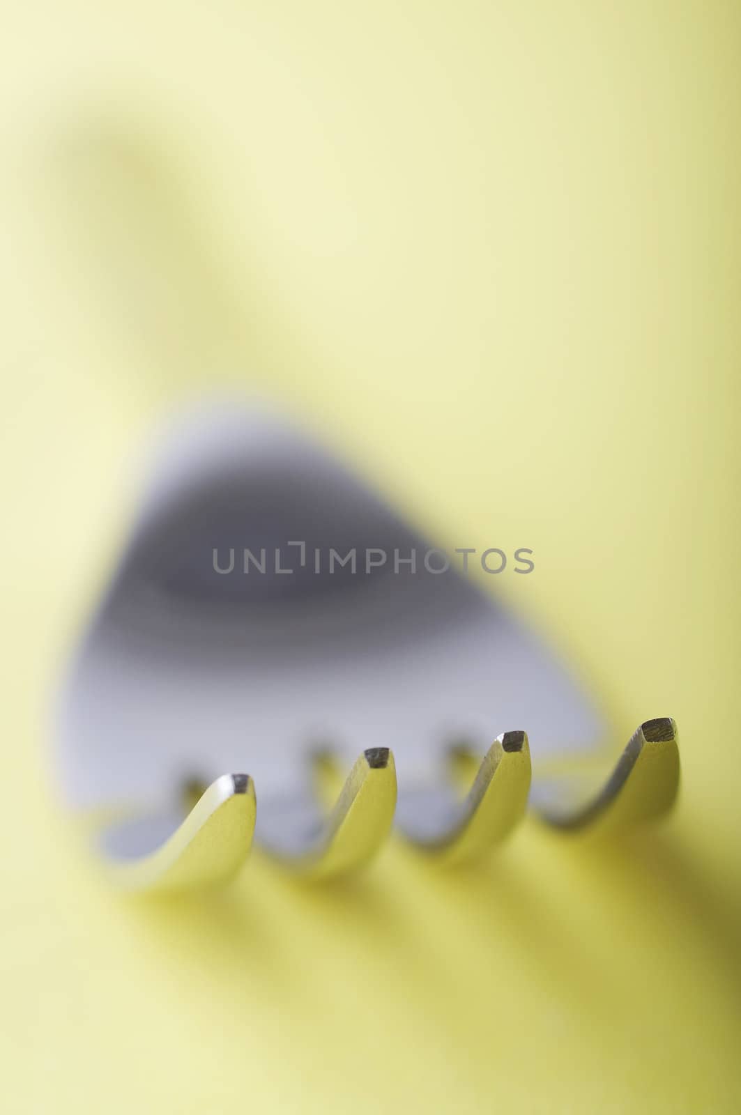 Close up of fork with shallow dof on the yellow table