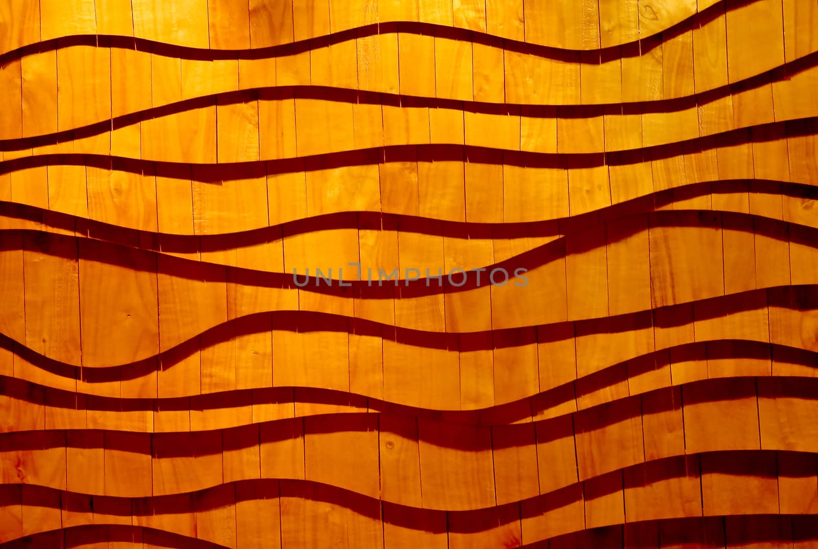 Wooden wall panels as flowing waves, casting shadows