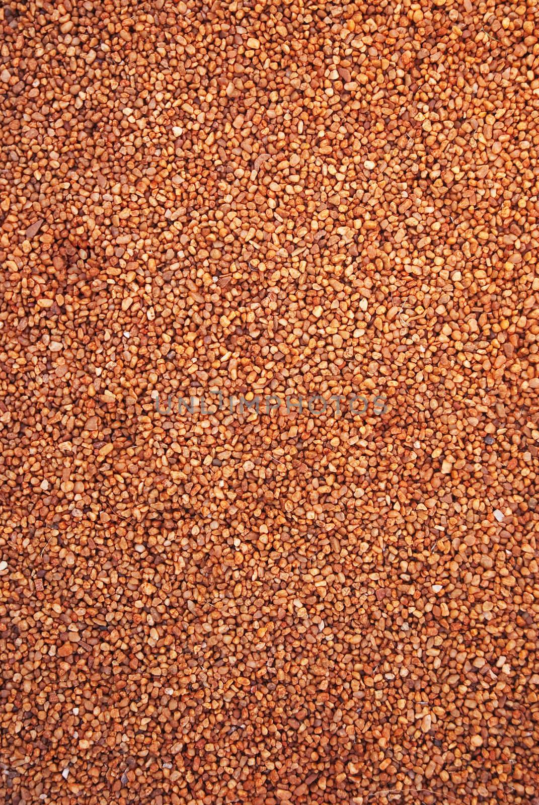 Texture shot of small red pebbles and stones, filling the whole frame