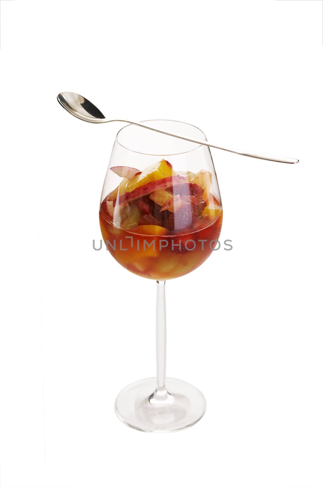 Fruit cocktail in red wine glass over a white background (isolated)