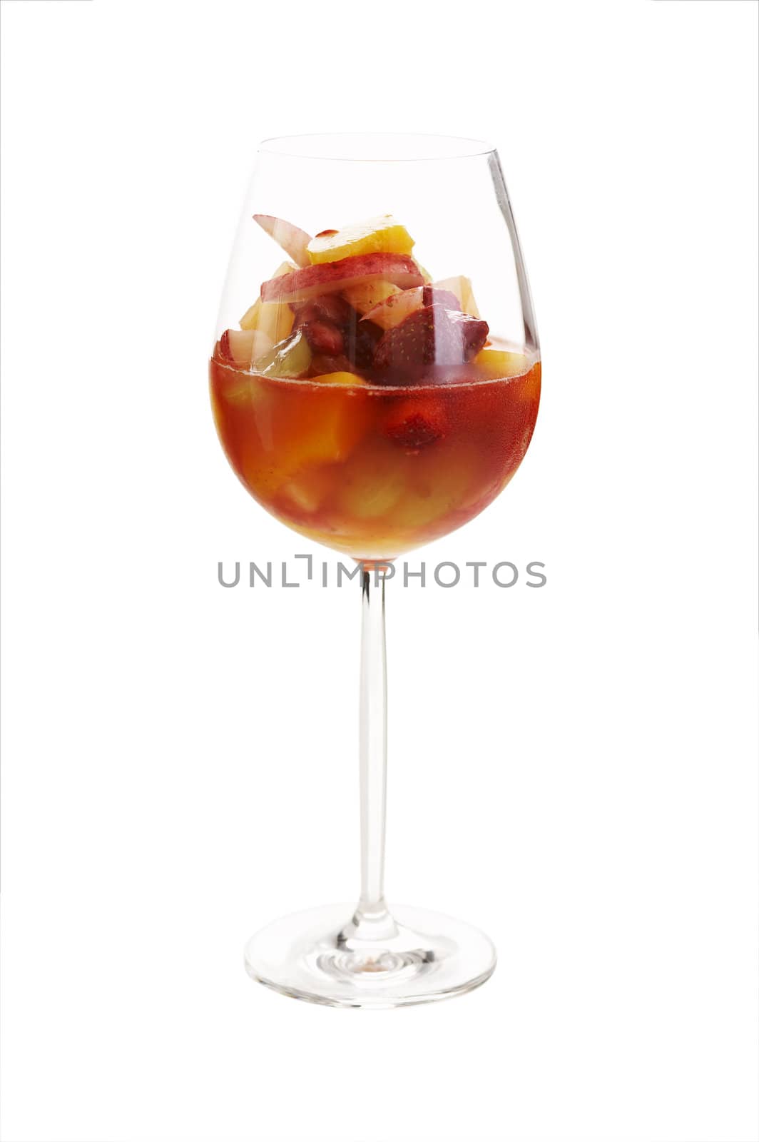 Fruit cocktail in red wine glass over a white background (isolated)