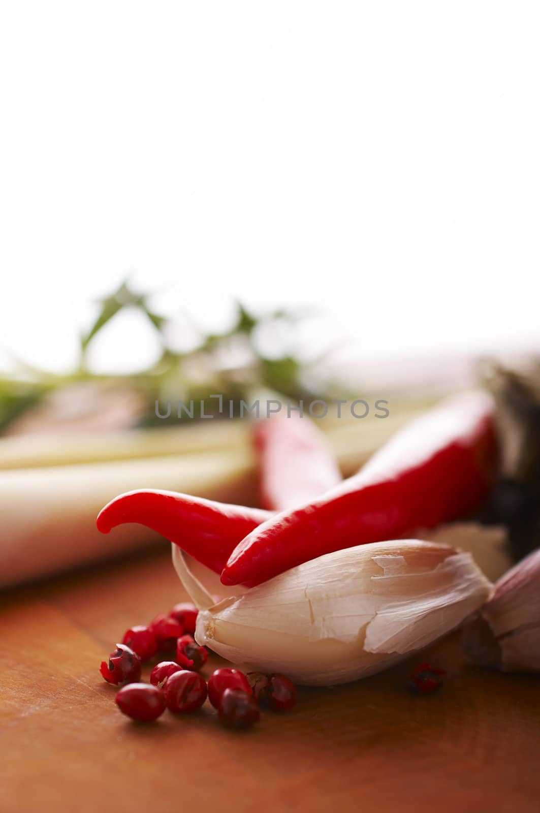 Thai food spices on wooden board (pepper, chili, garlic and lemon grass)