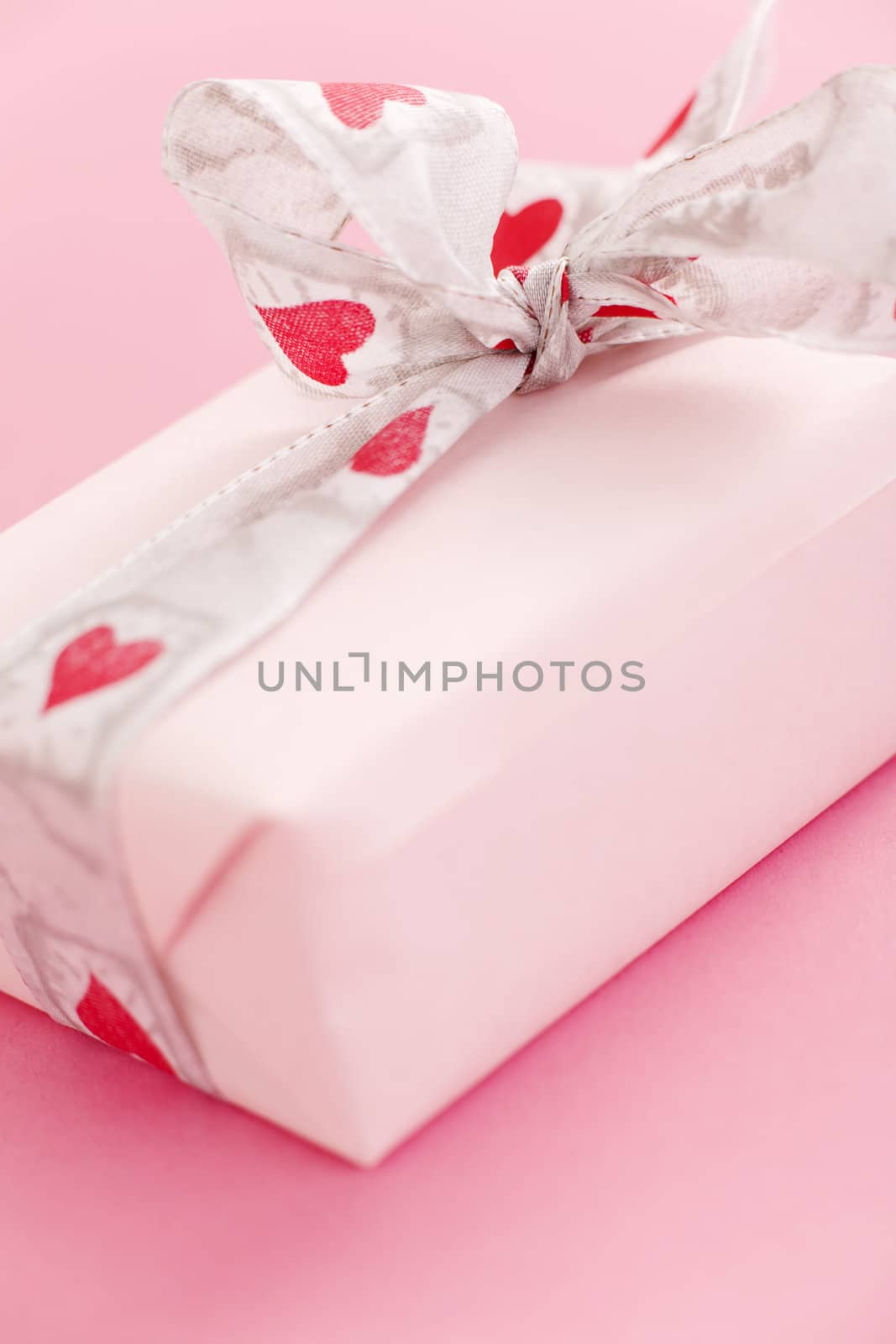 Pink gift box over a pink background