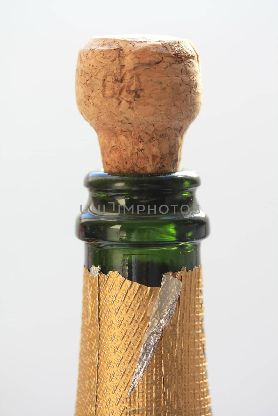 Close up of a champagne cork popping out of a bottle