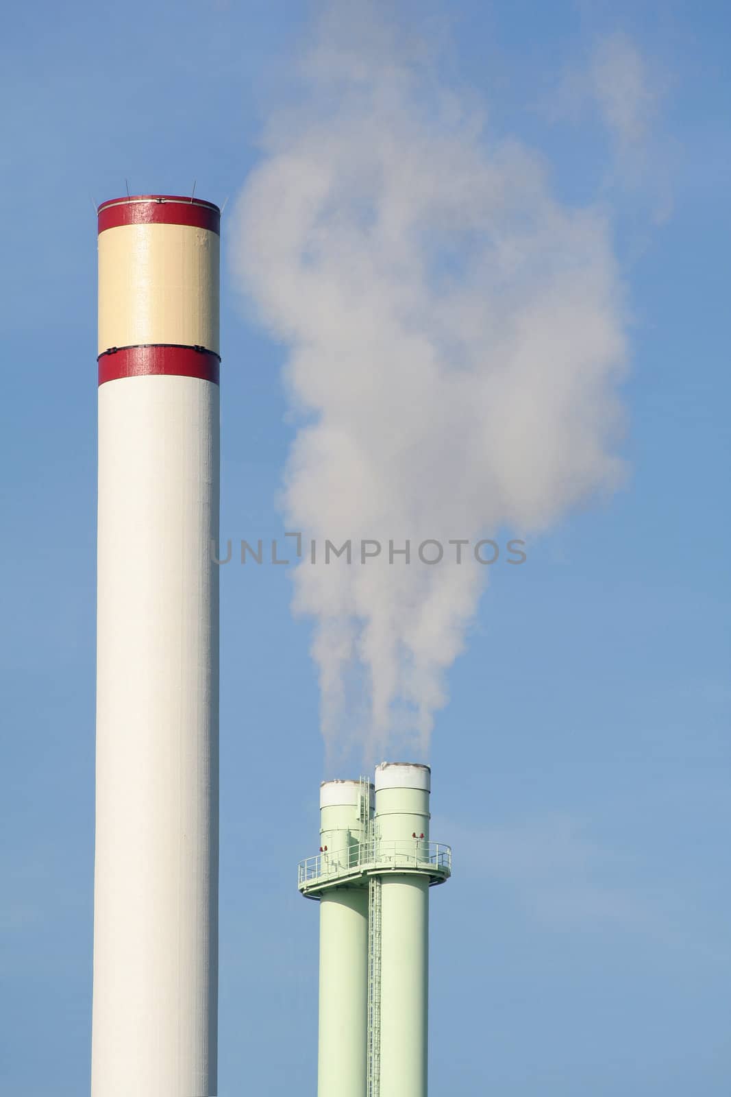 Two smoke stacks of an incinerating plant. Beautiful colours.