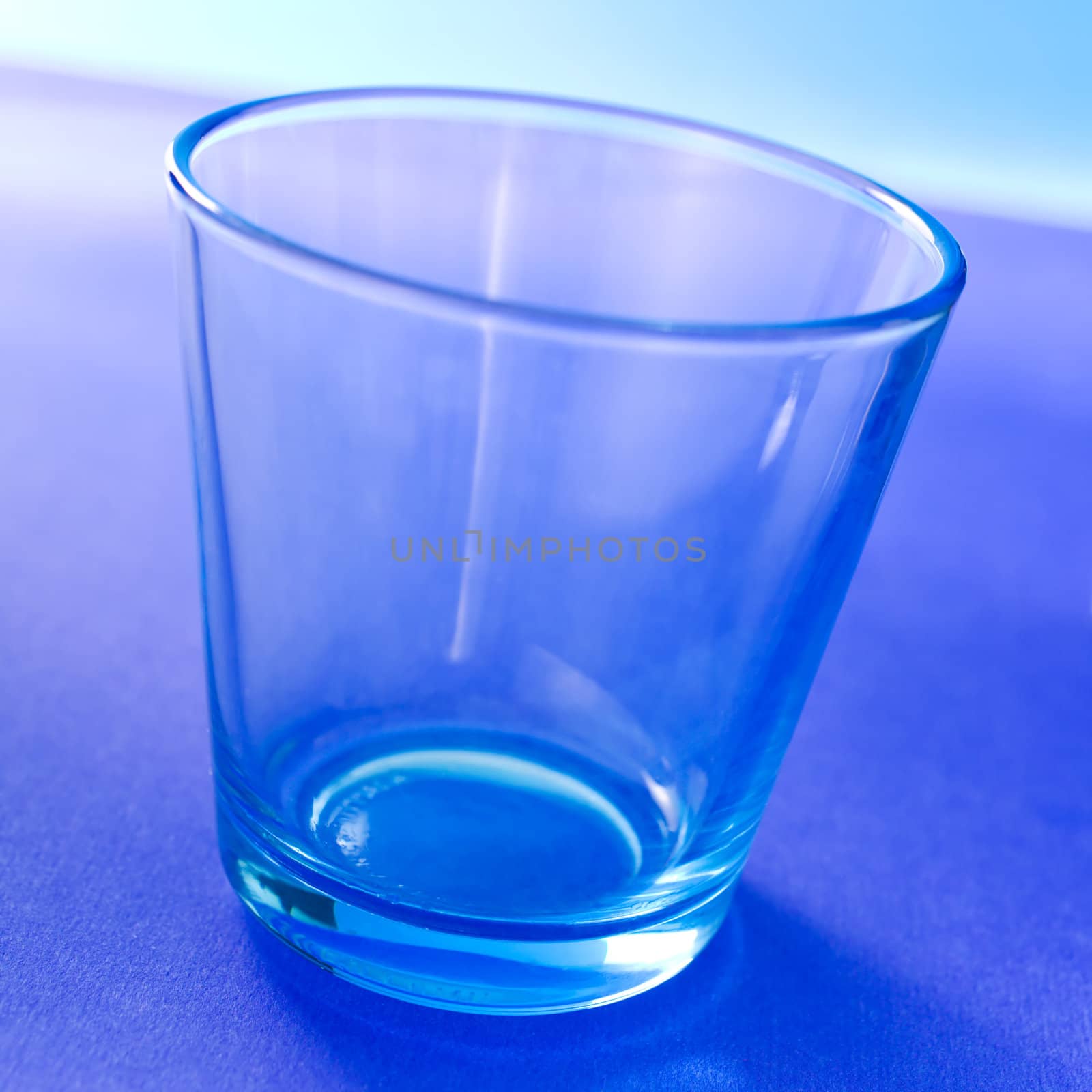 Empty light blue glass on the table