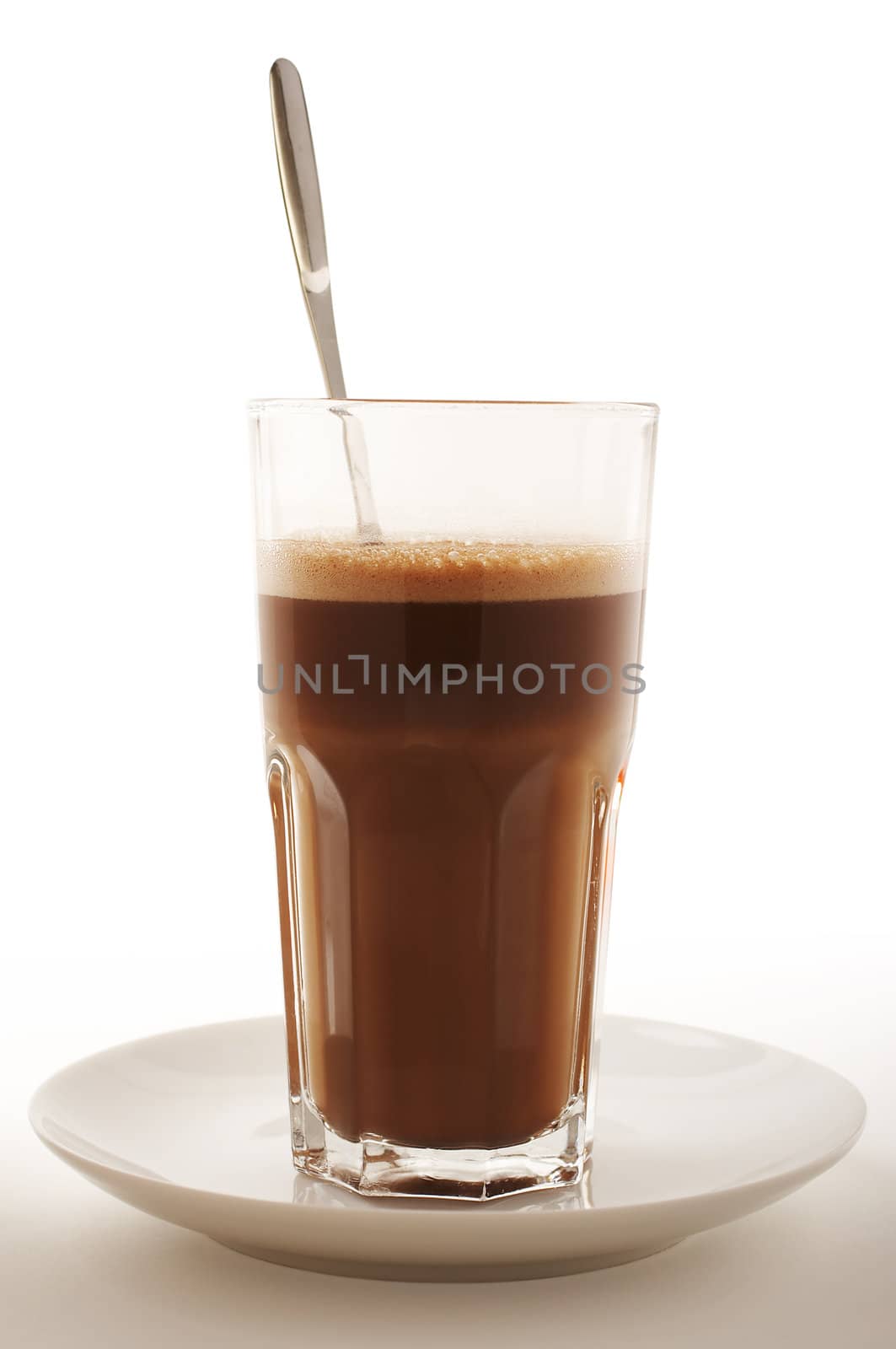 Glass of Hot chocolate with foam and spoon