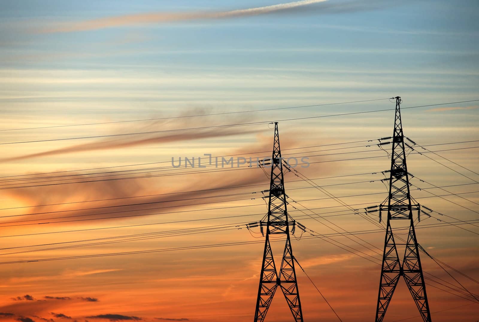 High voltage tower on a background of the red sky