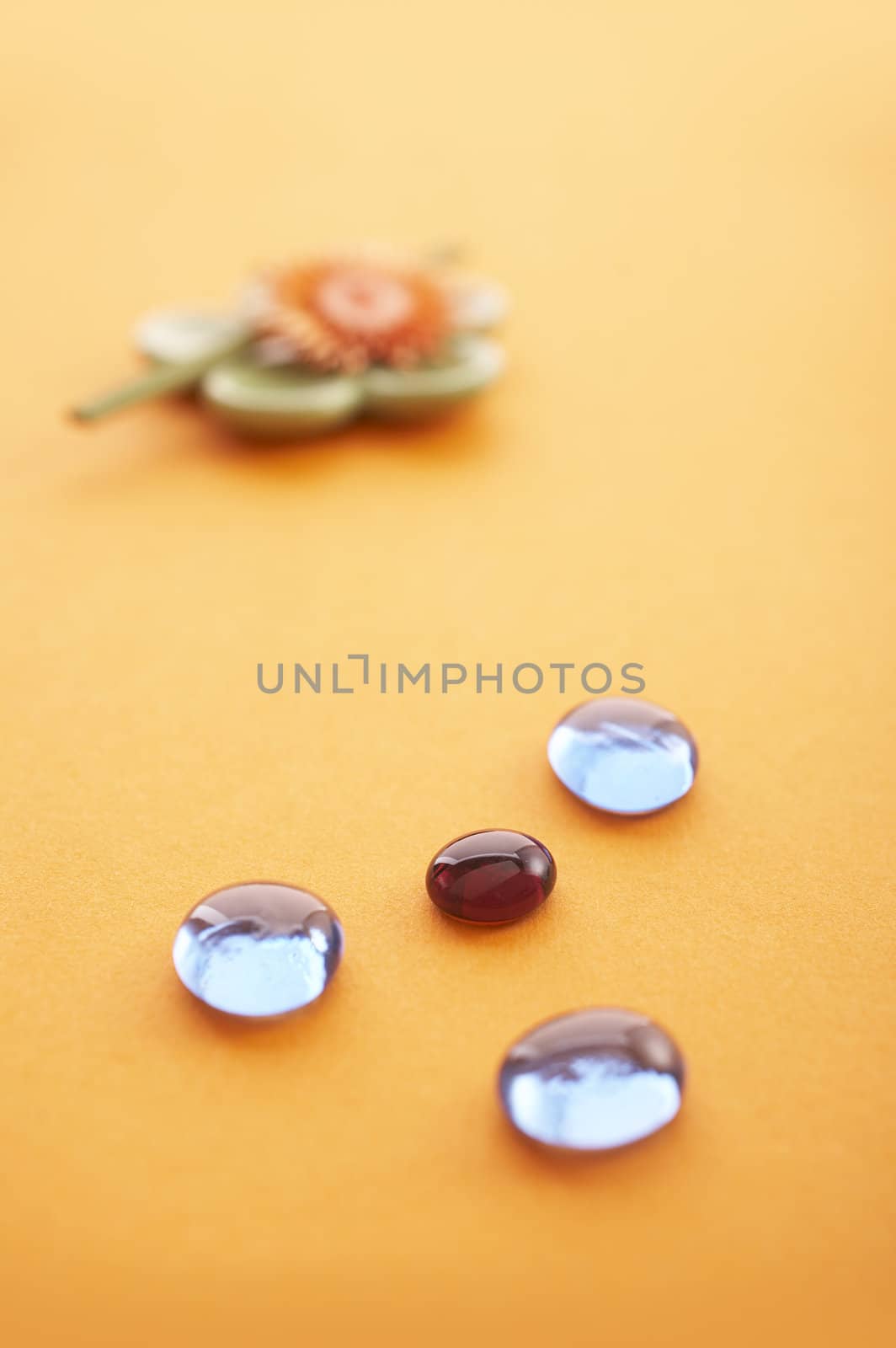 Incense sticks on the orange table with glass stones