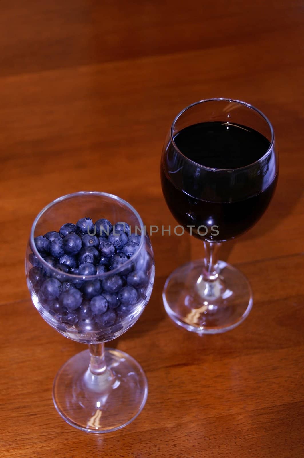 Blueberries and wine in wine glasses.