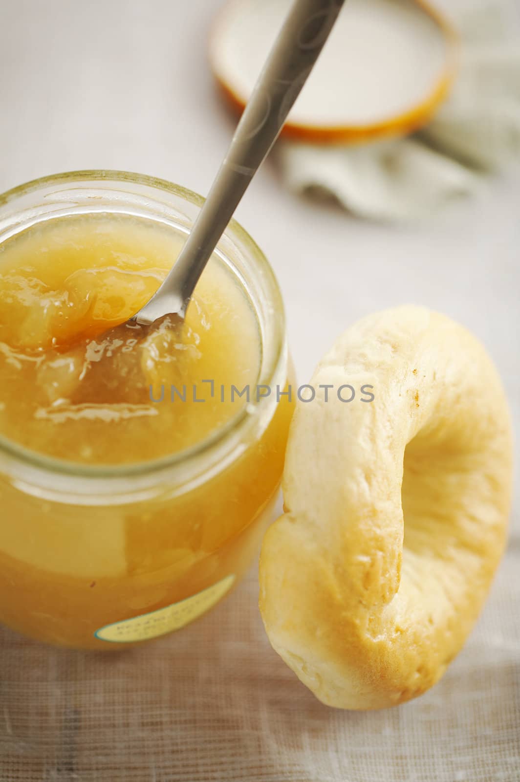 home made jam with spoon and bagel on the table