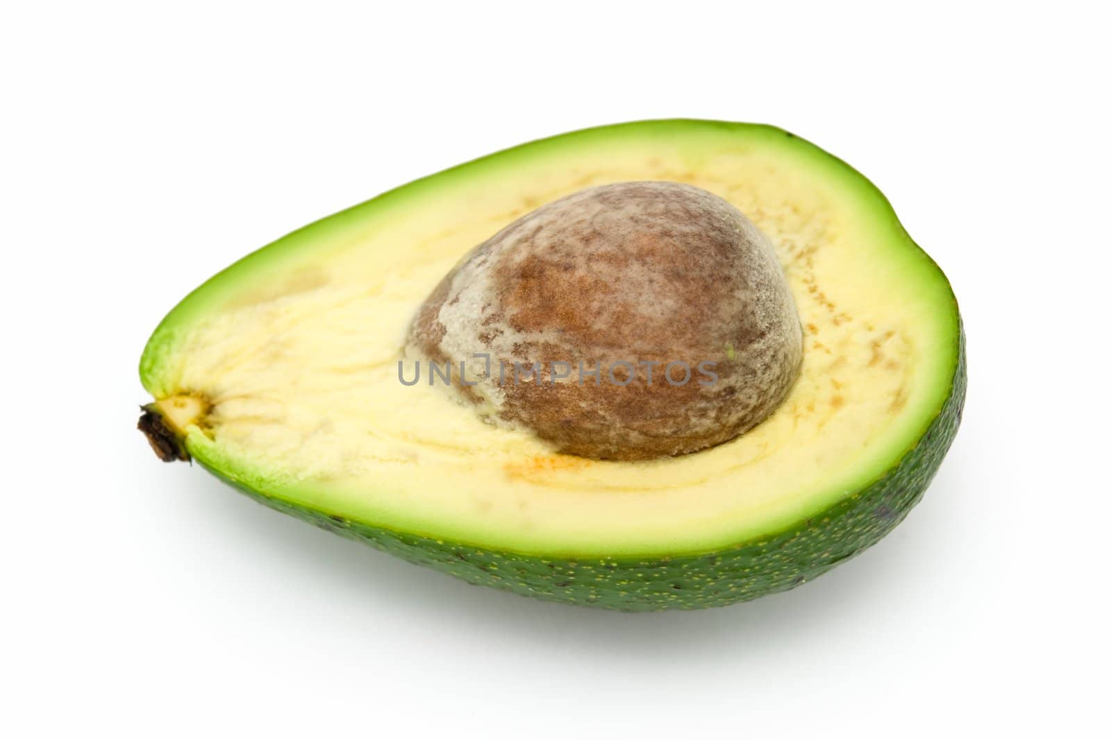 Half avocado with stone on a white background