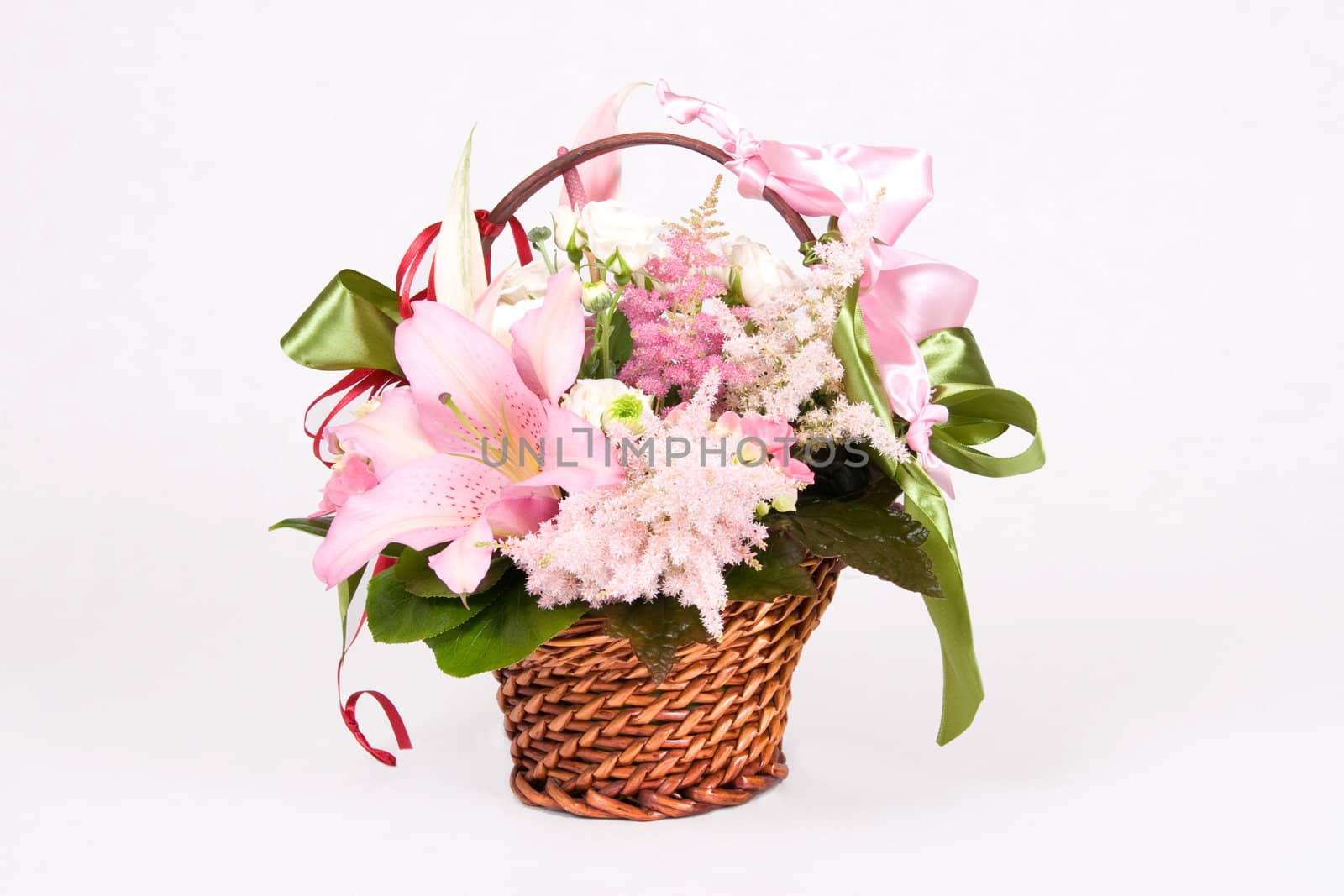 Basket full of variety flowers and green bow