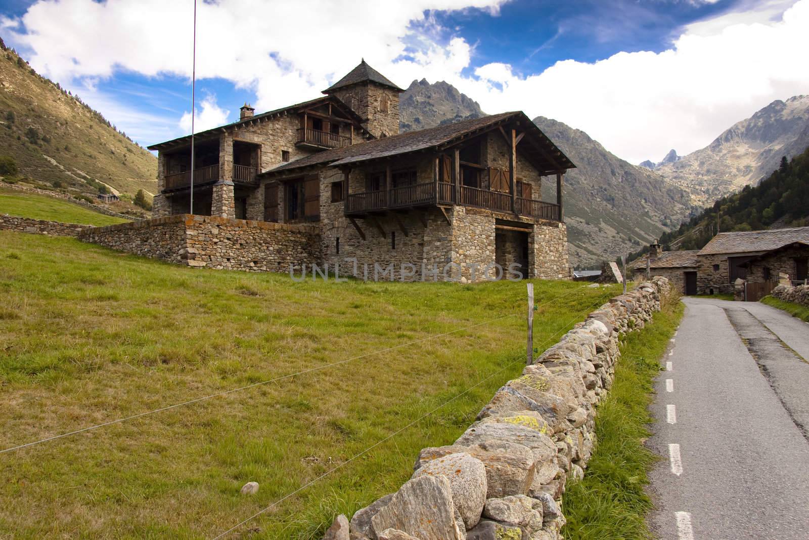 Big stony house in Pyrenees mountain - Andorra summer day, blue sky.
