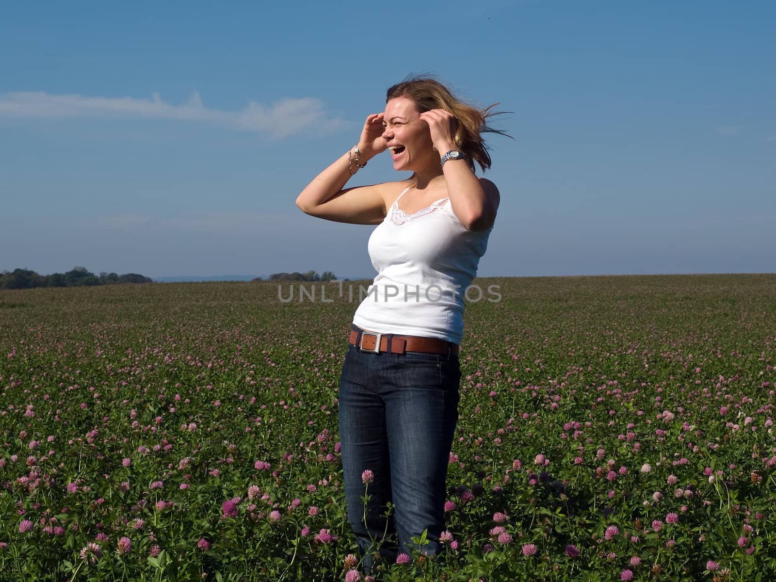 Beautiful attractive young happy woman girl in a flowers field