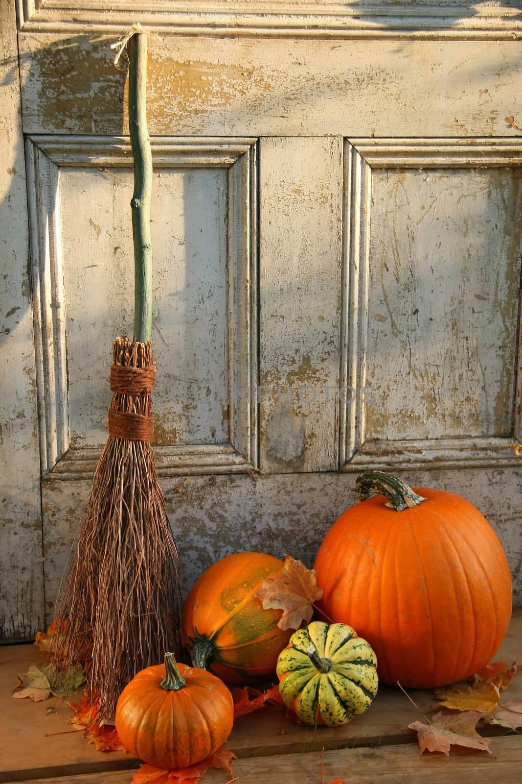 Pumpkin and gourds with old broom at the door by Sandralise