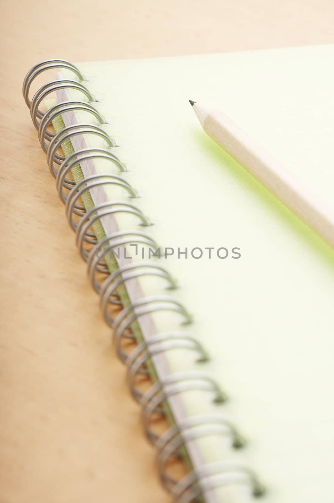 Pencil on the green spiral notebook cover