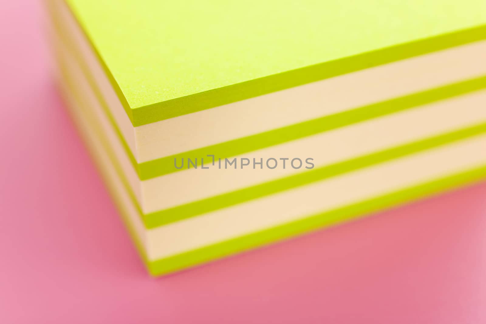 Pile of sticky notes over a pink table