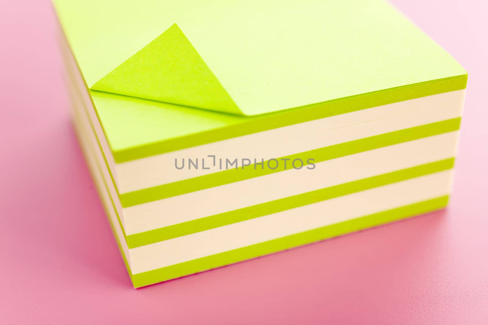 Pile of sticky notes over a pink table