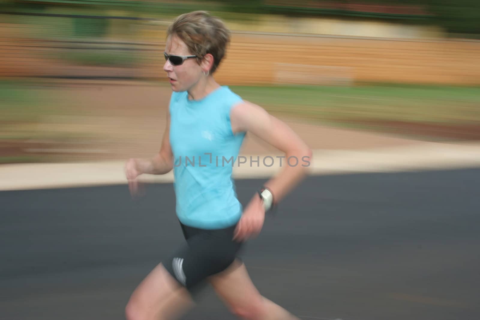 Artistic blur of a female athlete running fast