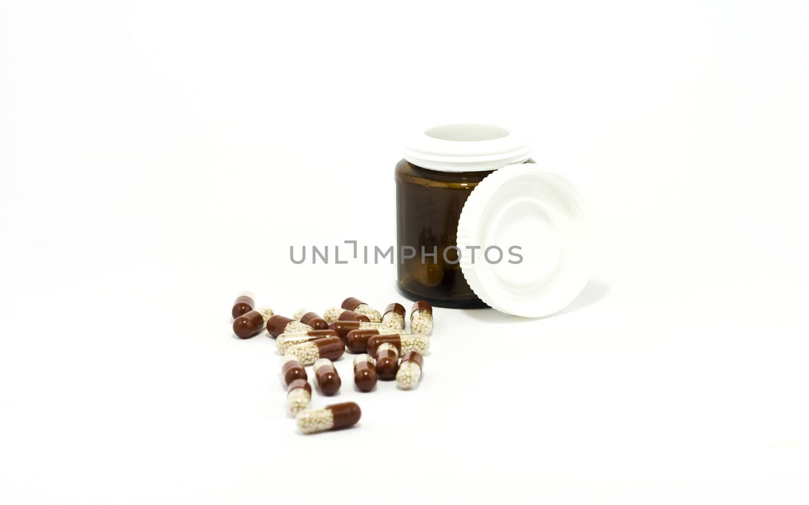 Pills and bottle on white background