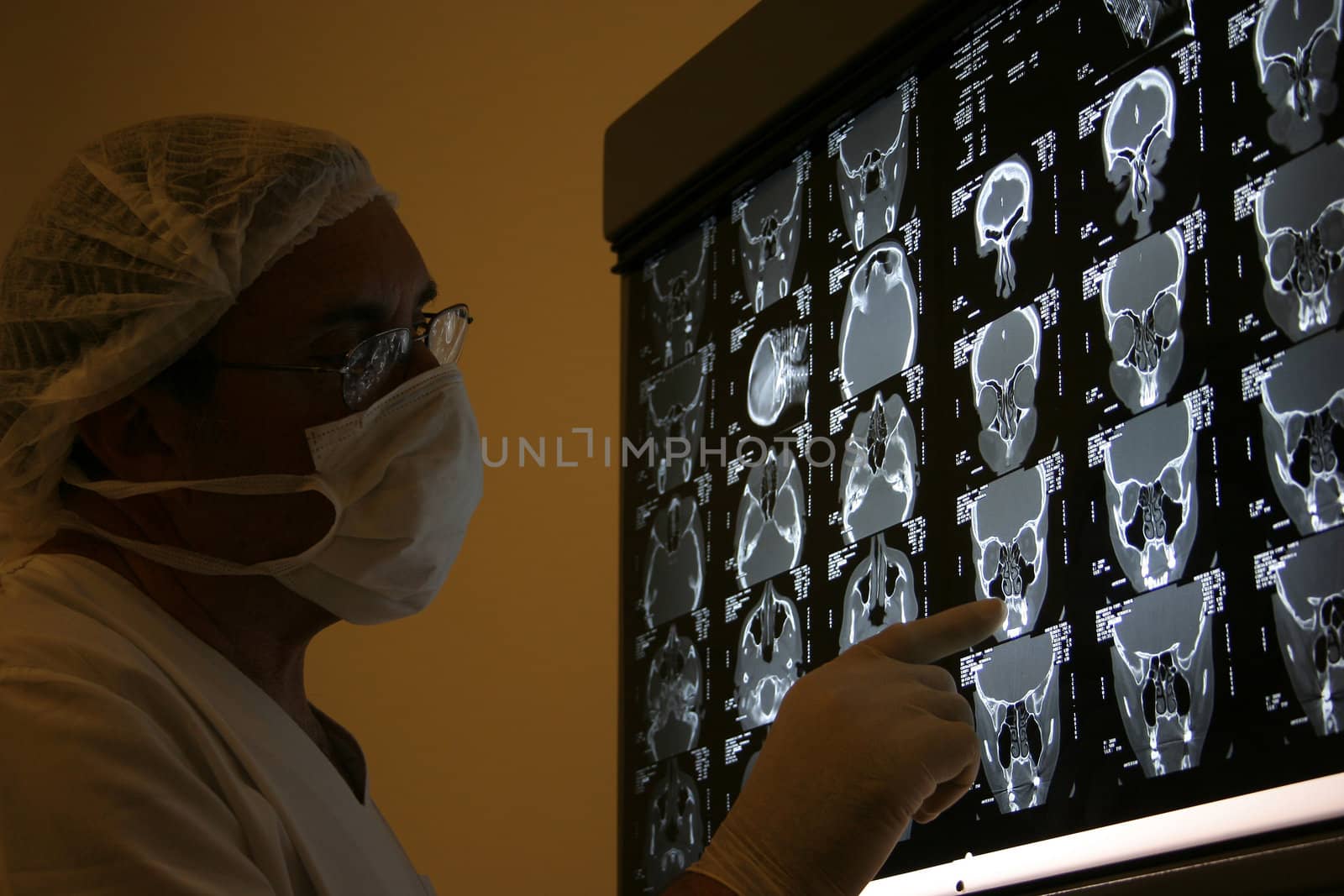 Doctor in surgical scrubs looking x-ray. Medical stuff at hospital