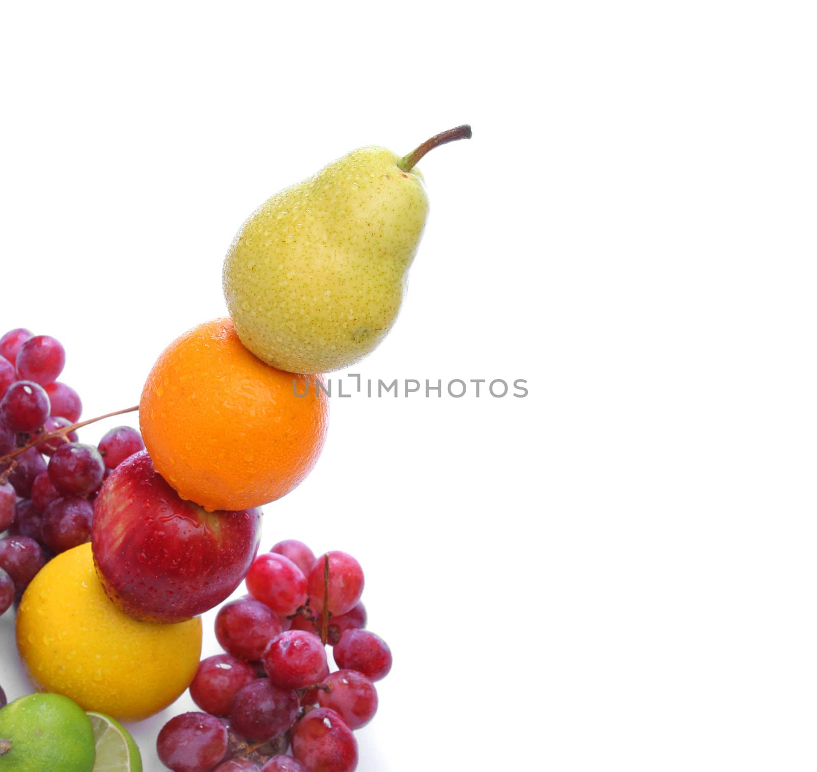 Pear, orange, apple and grapefruit totem with water drops with some grapes on the floor on white background. Look for more fresh fruits and vegetables at my gallery