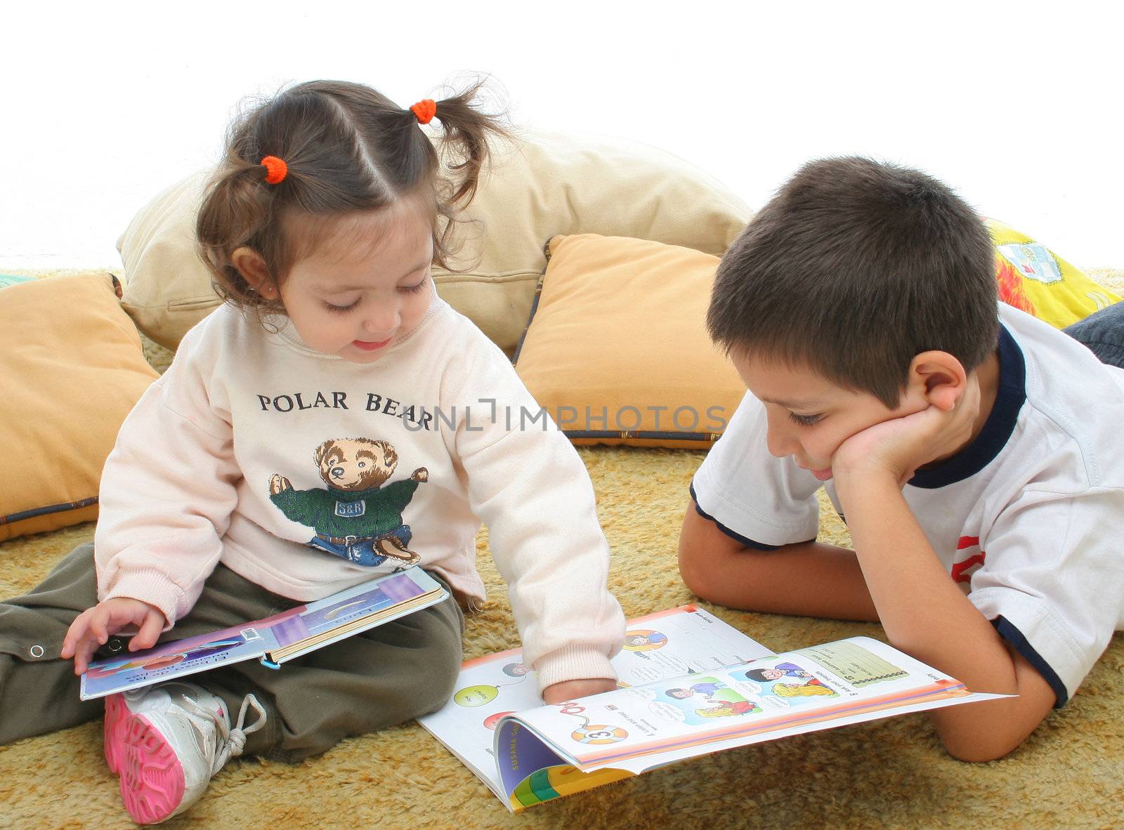 Brother and sister reading books on the floor by Erdosain