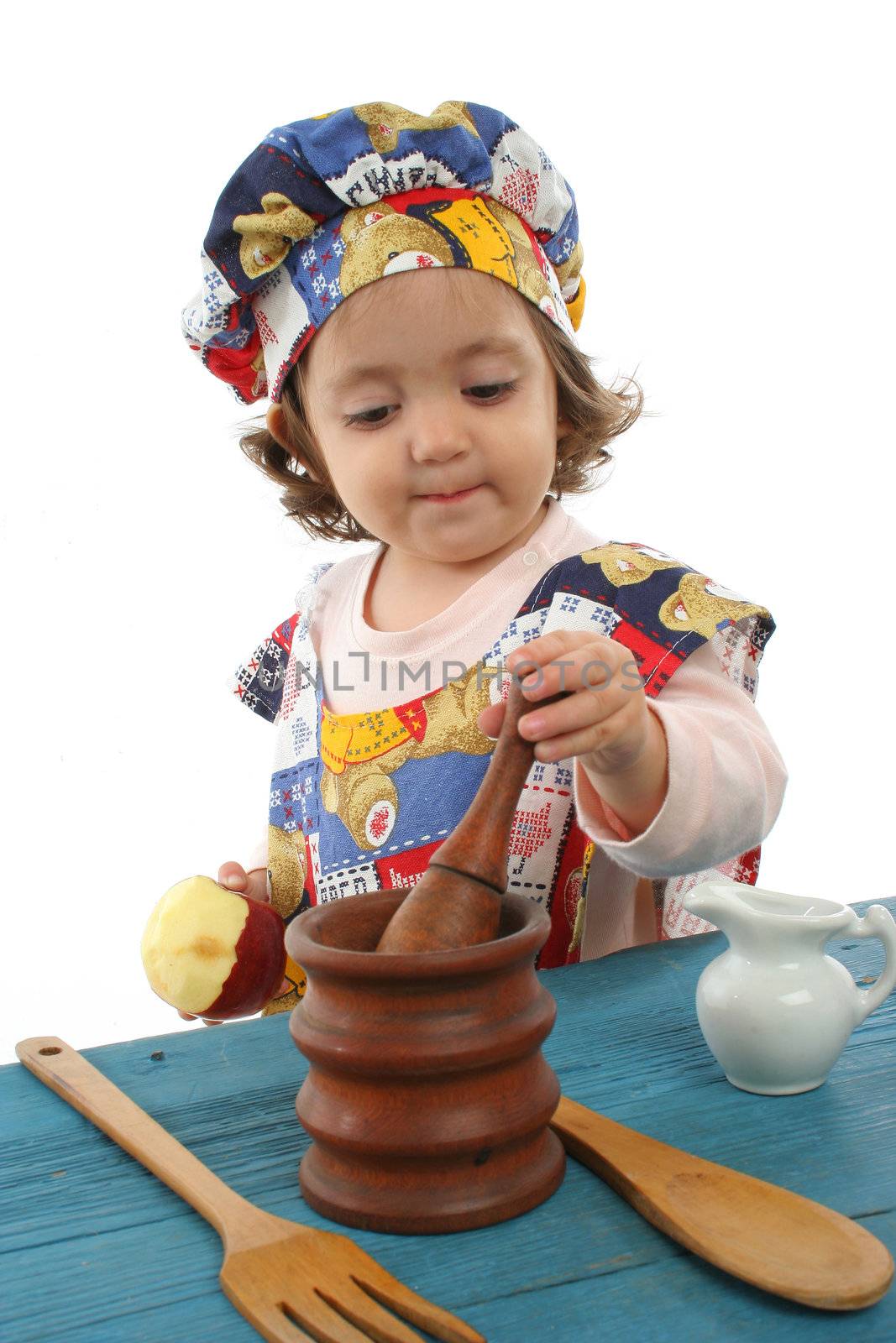 Little girl cooking dressed at a cheff by Erdosain